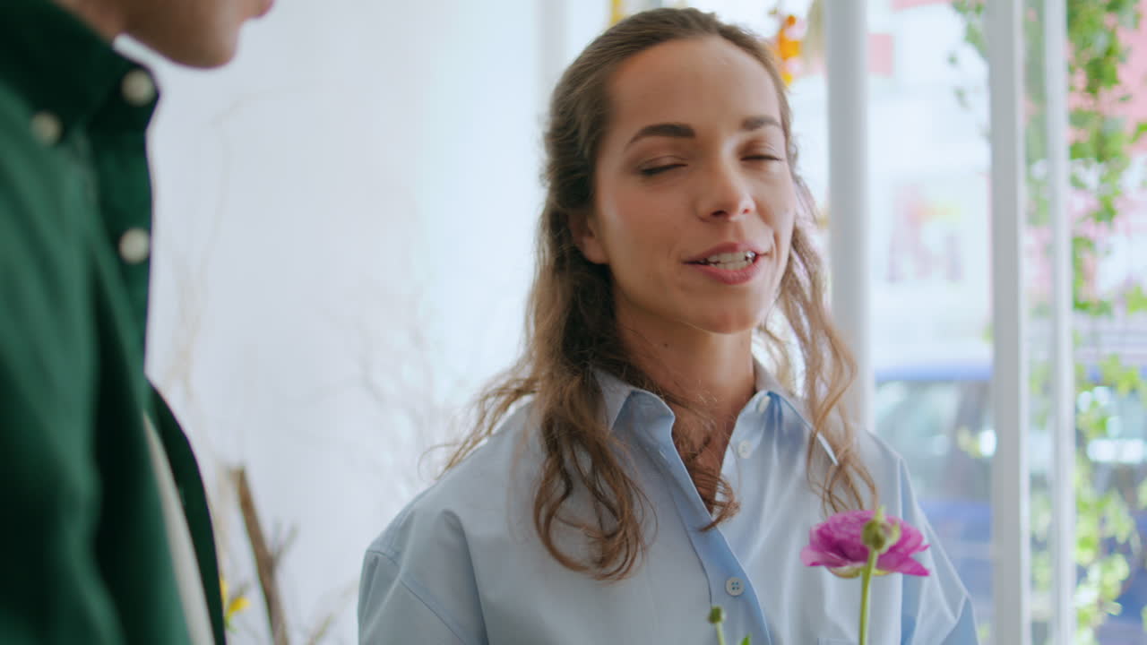 Attractive woman hold flowers roses in hands close up. Beautiful florist talk.