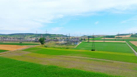 scenic fields and substation in summertime - aerial drone shot