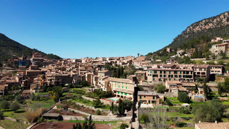 Slow-low-flyover-of-Deia-Mallorca-in-mountains-on-hot-sunny-summer-day