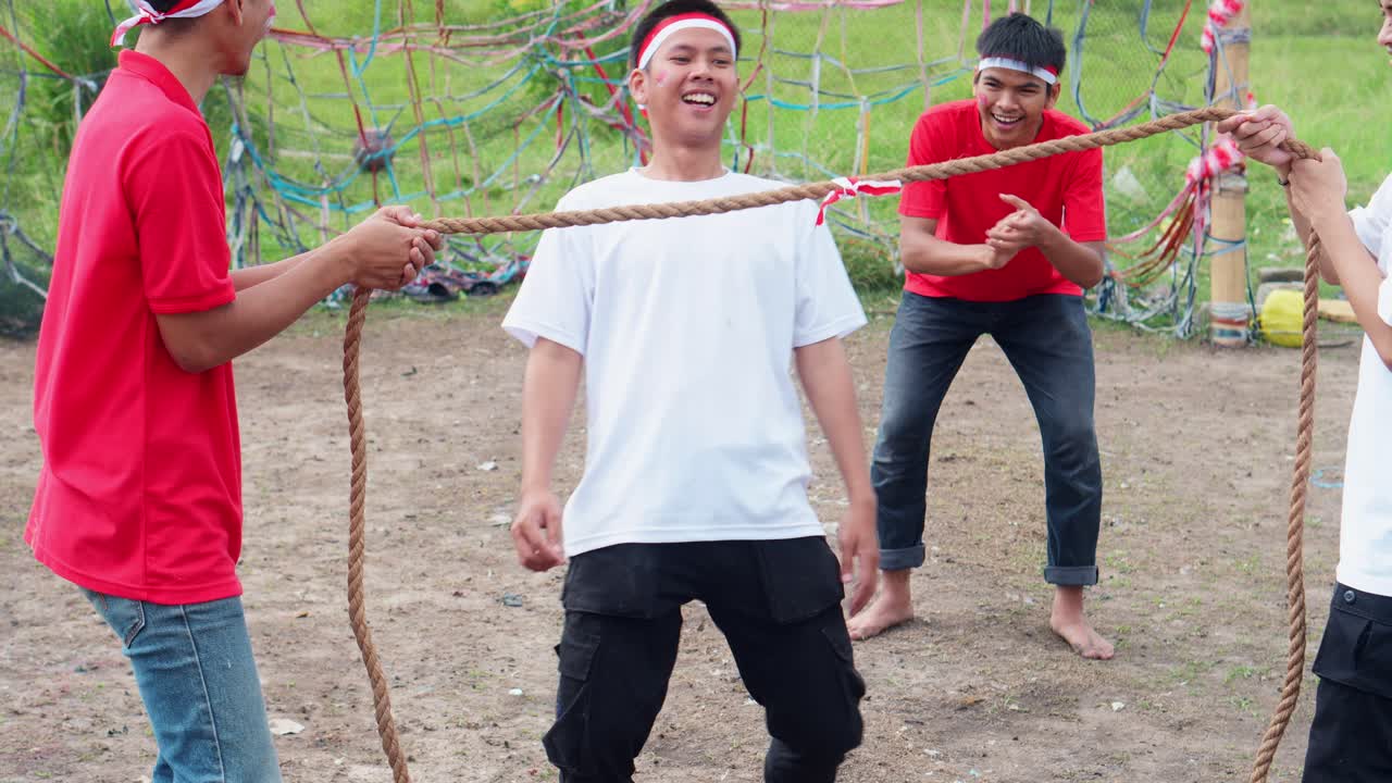 Young Indonesian Men Celebrating Independence Day With Variety Of Traditional Games And Activities