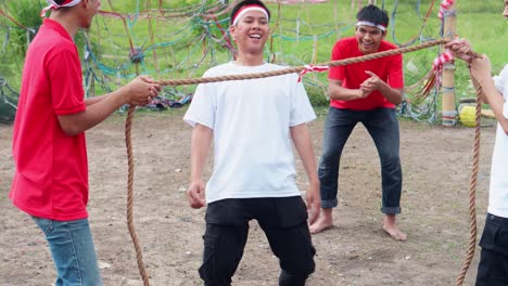 young indonesian men celebrating independence day with variety of traditional games and activities