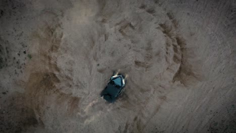 atv quad doing donuts, shot with drone top down view