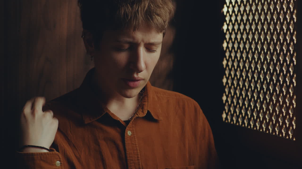 Young Faithful Woman Crossing Herself and Praying in Confessional Booth