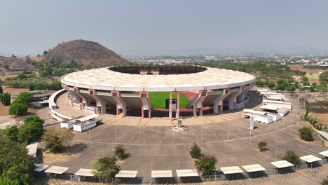 descending wide aerial shot of a football stadium in africa