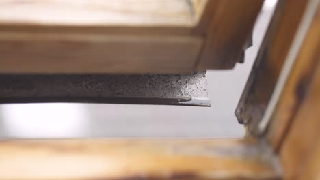 close-up of open window with leaking rain