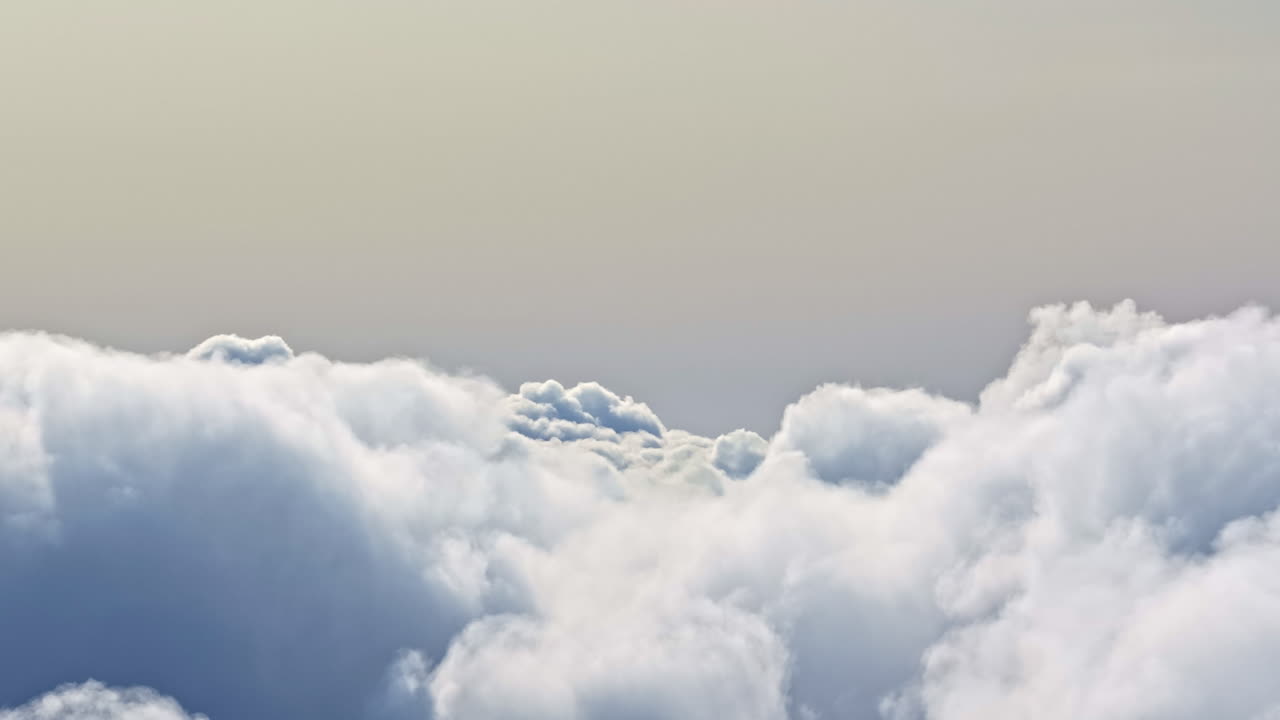 Peaceful view above a vast, beautiful cloudscape, creating a serene and dreamlike background of the sky at sunset - cinematic aerial tuck left