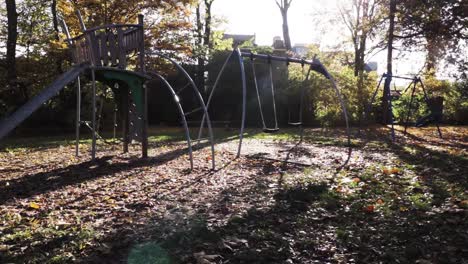 an empty playground, surrounded in autumn colors with swinging swings!