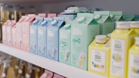 rows of pastel-colored beverage cartons on a store shelf