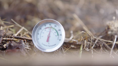 slow motion cu zoom in - steam rises around the compost thermometer