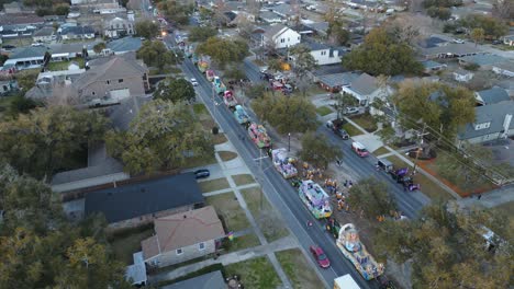 A-bustling-suburban-street-is-transformed-into-a-vibrant-spectacle-as-an-aerial-parade-captures-the-essence-of-community,-showcasing-the-diverse-urban-design-and-lively-residential-area