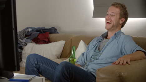 Young-Man-Drinking-Beer-And-Watching-Television