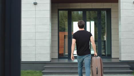 Tourist-man-caming-back-home-from-holiday.-Handsome-man-returning-from-journey