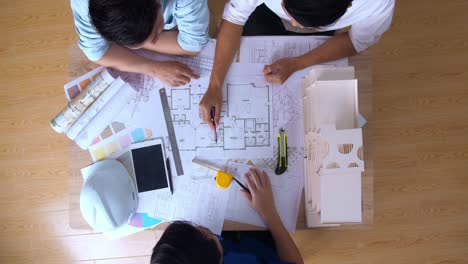 Top View Of Architects In Office Discussing Construction Project
