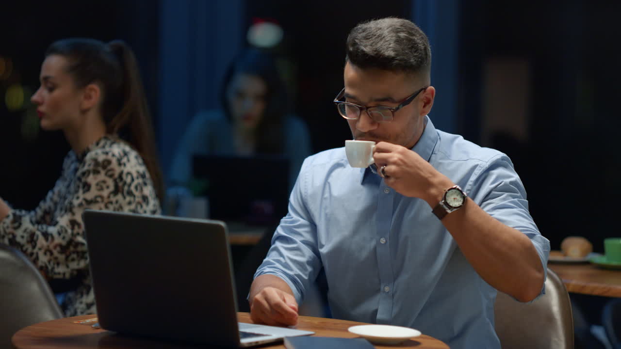 Indian business man drinking coffee in coffeeshop