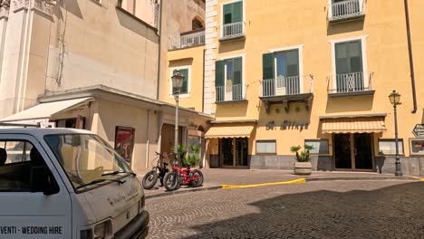 people and vehicles in a bustling town square