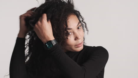 african american woman preening over white background.