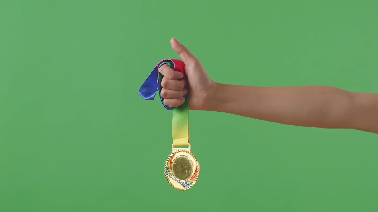 Golden Medal In Hand. Green Screen Background