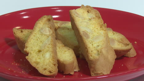 slices of almond biscotti on a red plate