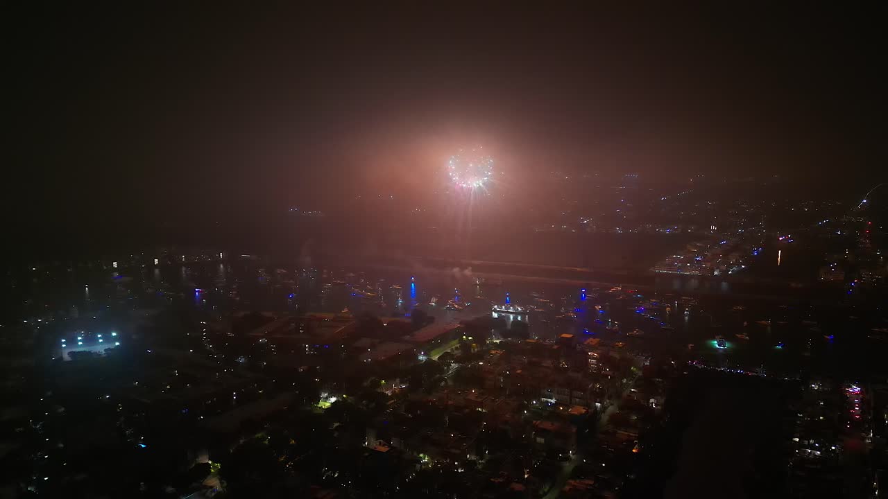 Aerial View of Fireworks Over City at Night