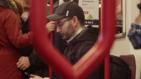 caucasian man using cellphone in public transport, closeup view