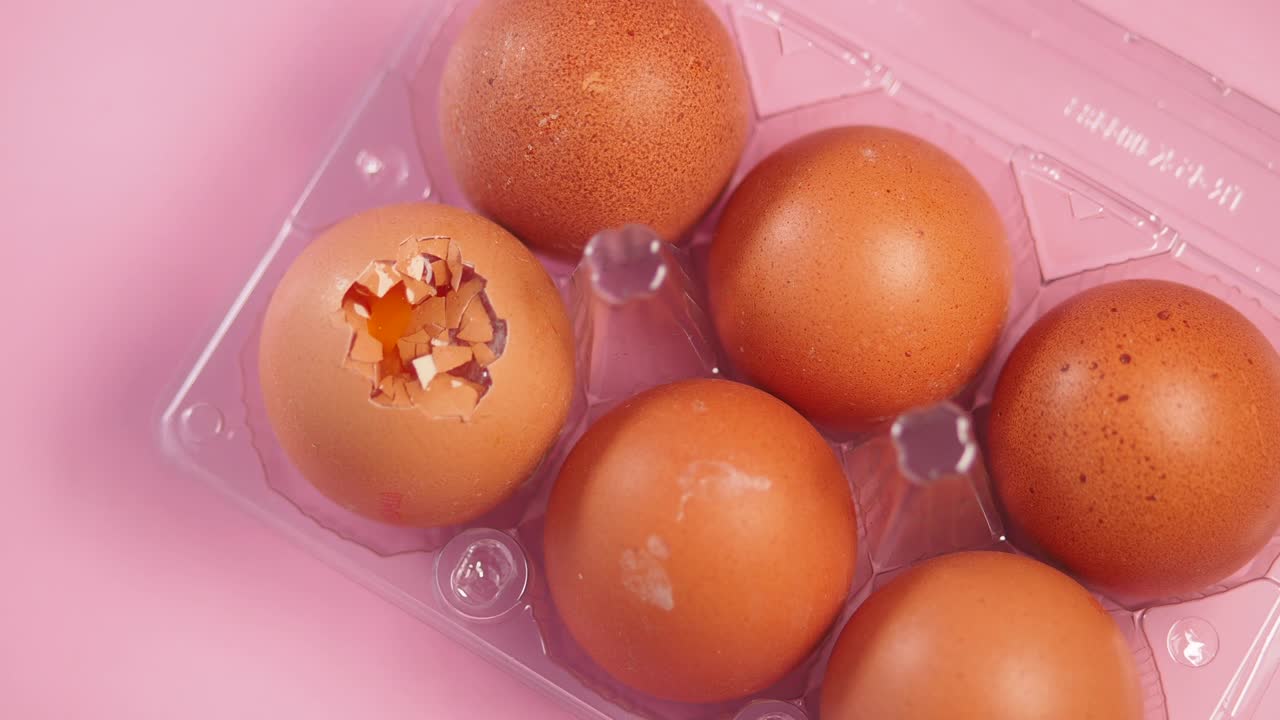 Eggs in a carton with one broken