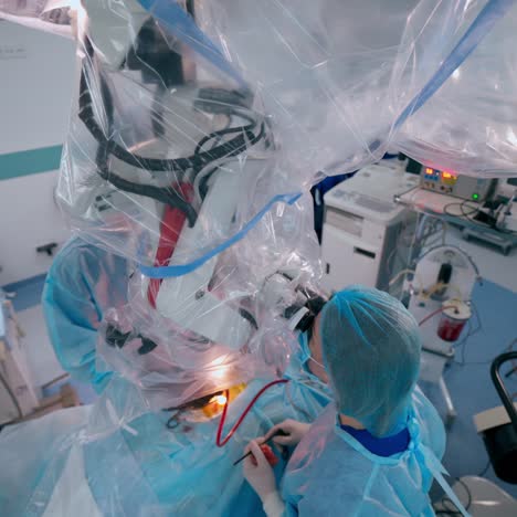 new technologies in medicine. neurosurgical procedure on the background of modern medical equipment. specialists perform an operation on a patient in hospital.
