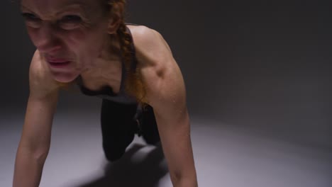 Studio-Shot-Of-Mature-Woman-Wearing-Gym-Fitness-Clothing-Doing-Mountain-Climber-Exercise-5