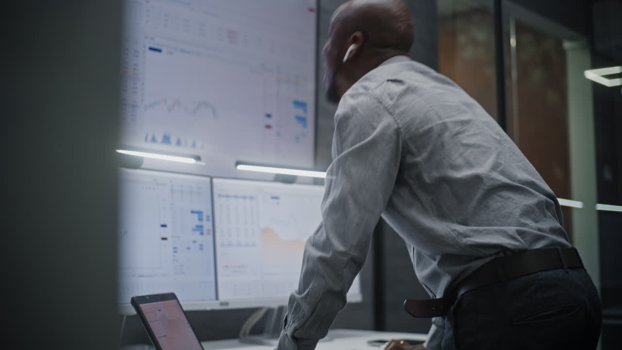 Financial Analyst Suffering from Financial Crisis, Yelling in Phone, Analyzing Real-Time Market Charts in Office. African American Businessman Furious About Stock Market Collapse. Vertical Shot.