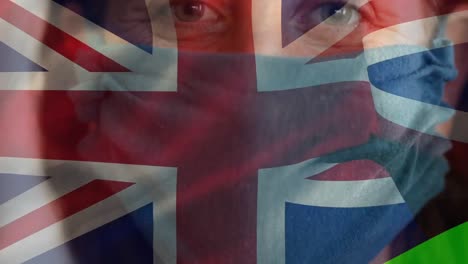 British-flag-waving-against-woman-wearing-face-mask