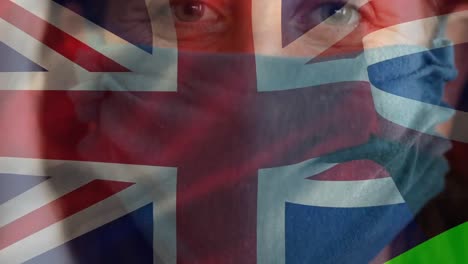 bandera británica ondeando contra una mujer con una máscara facial