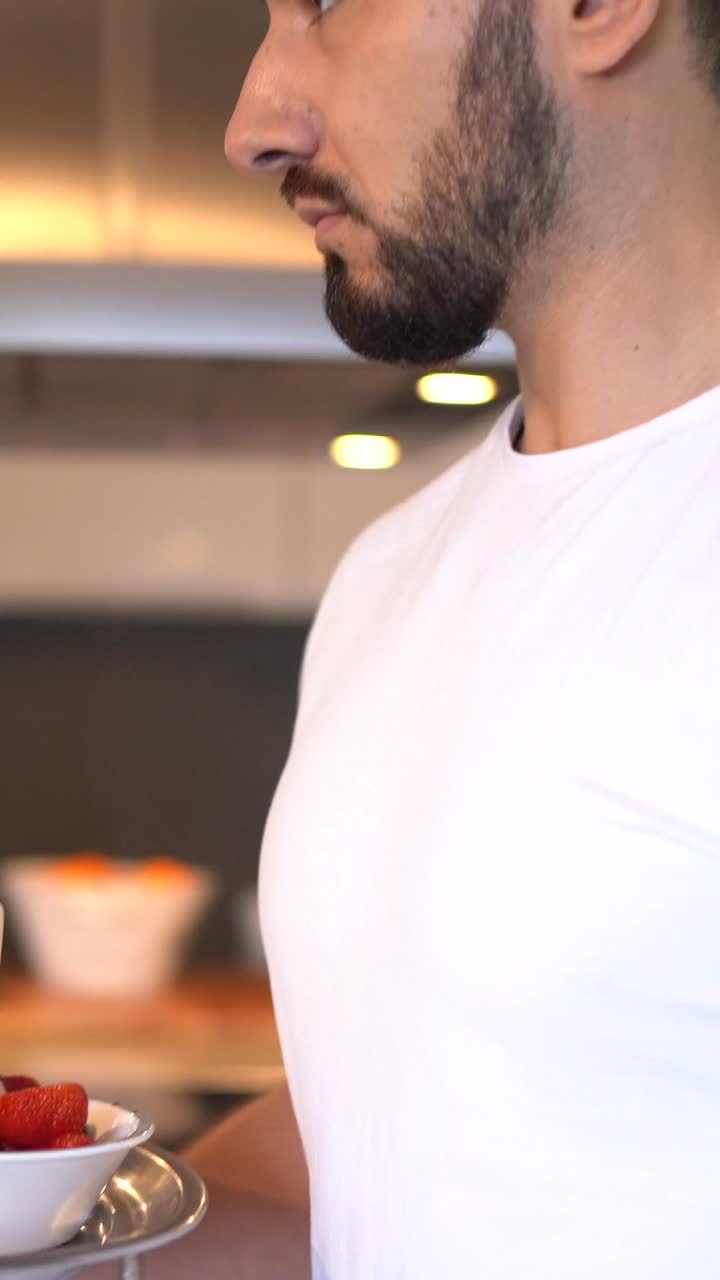 Man carrying breakfast tray with croissants and orange juice