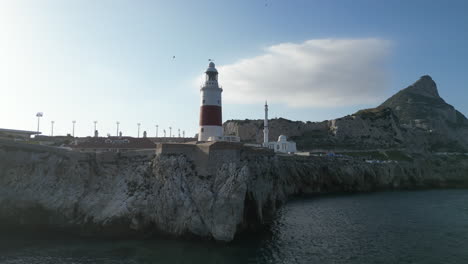 A-beautiful-4k,-low-flying-reverse-tracking-shot-from-cliffs-in-Gibraltar-below-it's-lighthouse