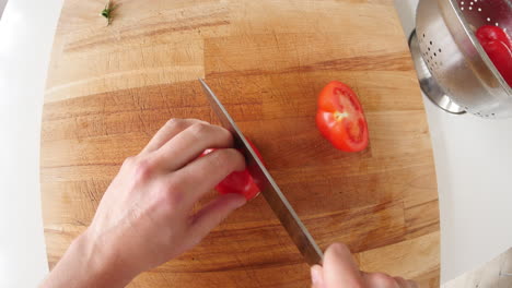 point of view of man chopping tomato and mushroom