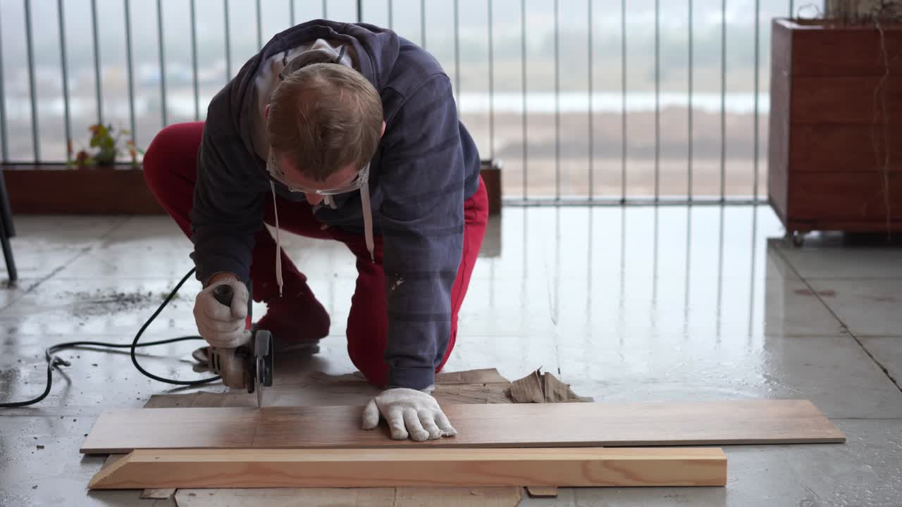 repair and decoration. a man cuts ceramic tiles with a grinder.