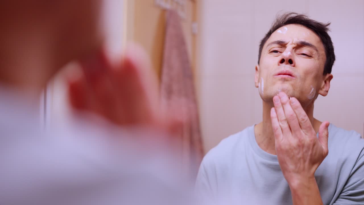 Man applying face cream and cocoa on lips