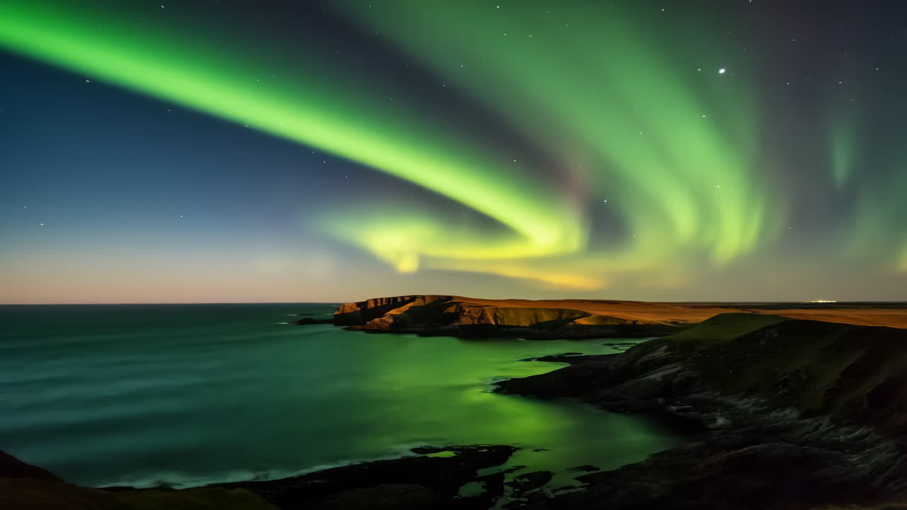 Vibrant Northern Lights Over a Coastal Landscape at Night