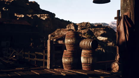 wooden barrels stacked against a mountain backdrop