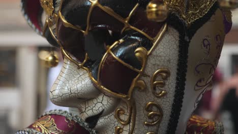 detailed close up of venezia carnival mask with city street in background