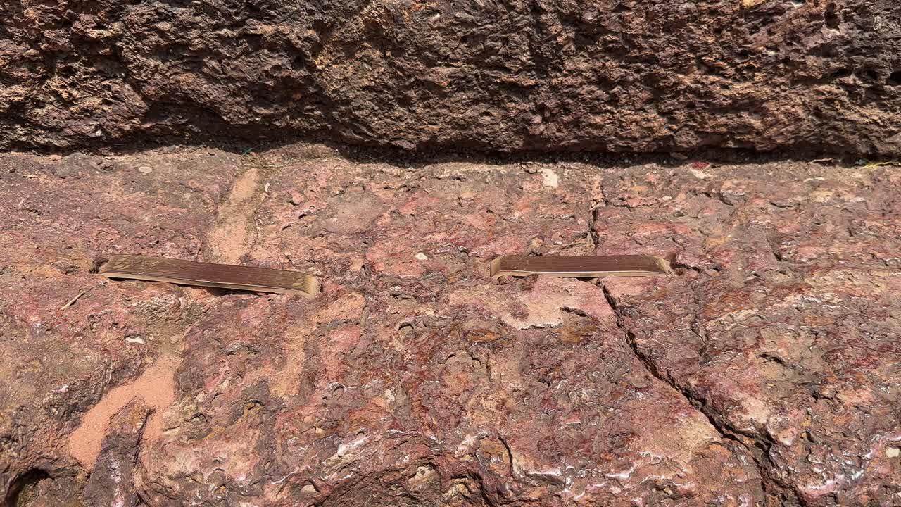 closeup of the metal link an old technology used in the binding two stone structure