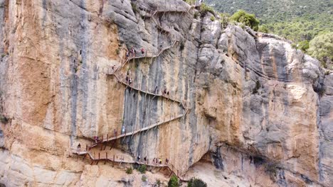 pasarelas de montfalco at congost de mont rebei canyon, catalonia and aragon, north spain - aerial drone view of tourists walking the scary stairs and hiking trail along the steep cliffs