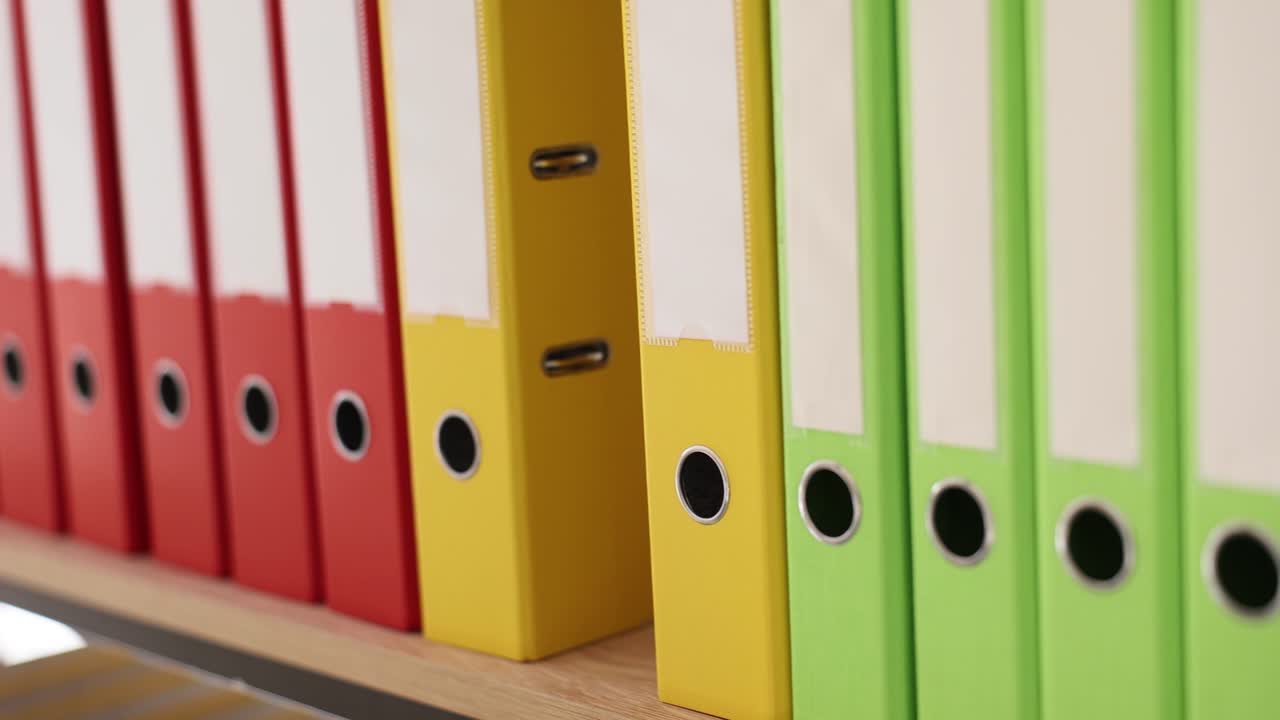 Colorful binders on a shelf for document organization