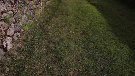 grassy inca road with stone retaining walls near the kusilluchayoc - el templo de los monos in cusco, peru