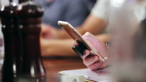 People-using-phone-during-dinner-at-the-restaurant