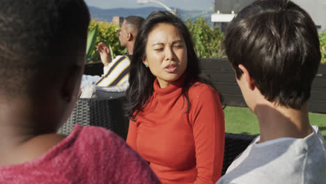 Group-of-friends-discussing-on-a-rooftop