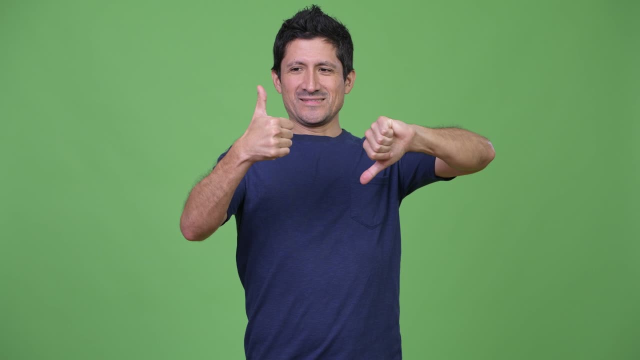 Hispanic man choosing between thumbs up and thumbs down