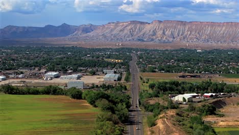 summer grand mesa downtown main street grand junction colorado river aerial drone forward pan up motion afternoon cloudy blue sky wine vineyards parachute fruitvale mt garfield western close delta usa