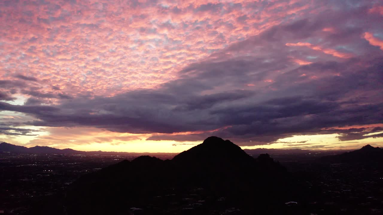 Beautiful pink sunset with the silhouette of Camelback Mountain in the middle