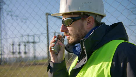 supervisor relaying message via handheld telecommunications device. slow-mo