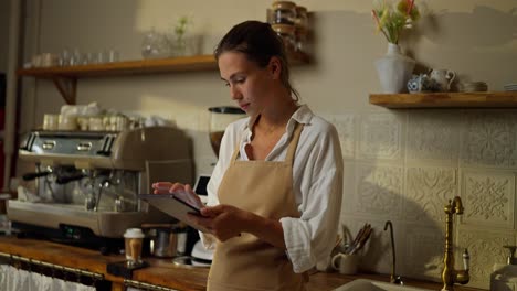 barista using tablet in a coffee shop