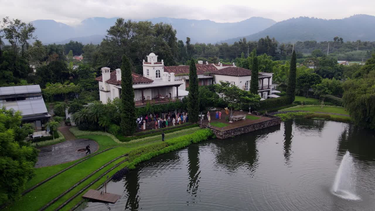4K aerial view of the majestic volcano in Antigua, Guatemala, on a hazy day. The scene highlights the volcano’s grandeur against a soft, misty backdrop